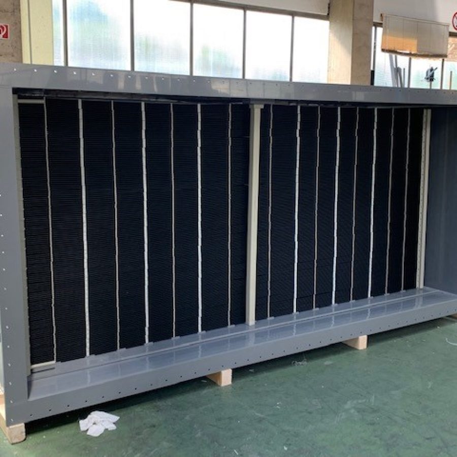 Polypropylene heat exchanger for dehumidifying and cooling exhaust air in a food processing facility