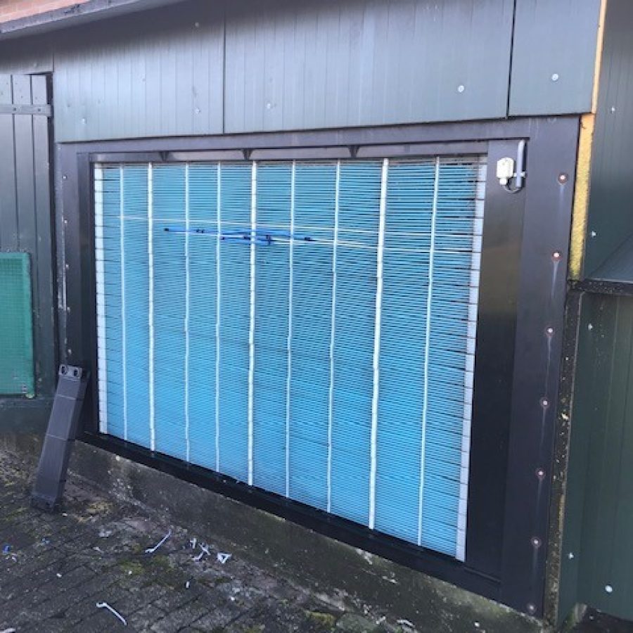 Corrosion-resistant plastic heat exchanger preheating and cooling incoming air in livestock barn ventilation